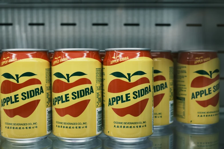 cans are lined up on a shelf with labels