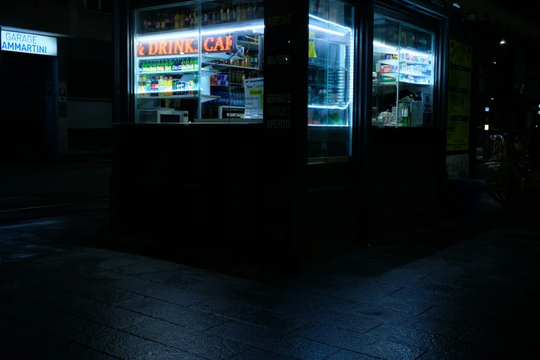 a shop called for dark is illuminated in a darkened area
