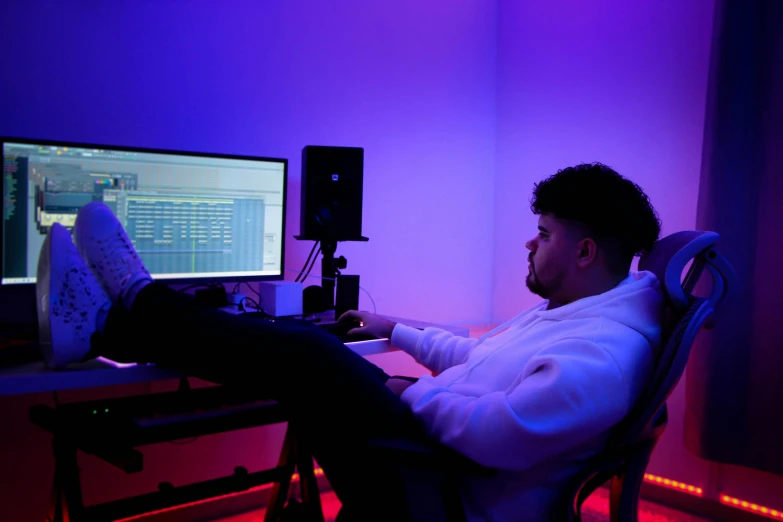 a man sitting at his desk typing on a keyboard