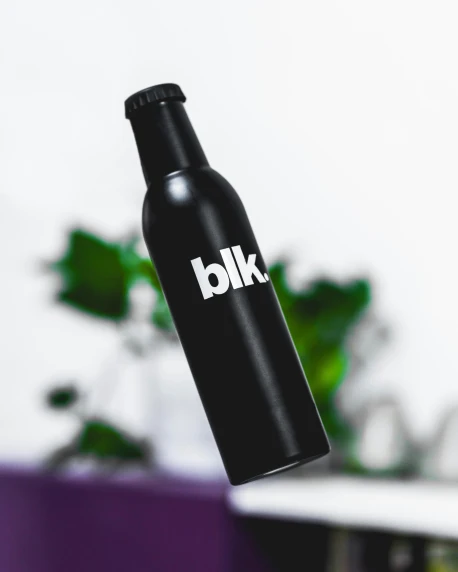 the bottle is hanging from the roof, with the word klb written in white