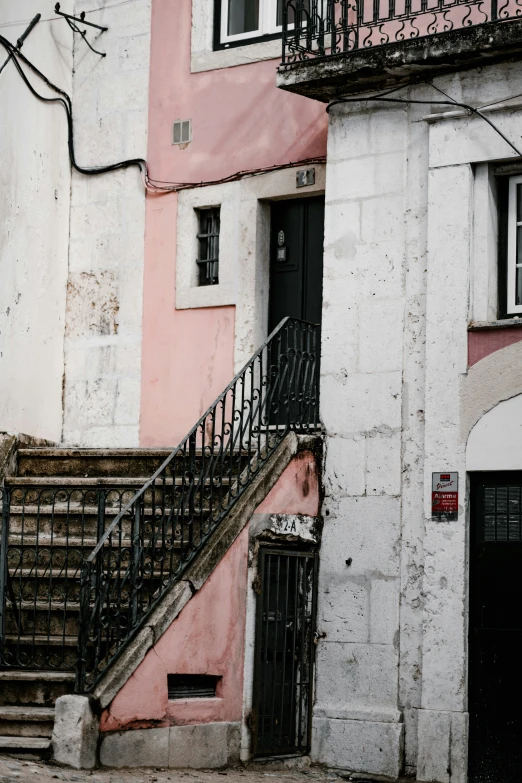 a staircase in front of a dilapidated building