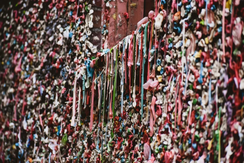 a bunch of beads hanging up on a wall