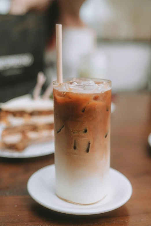 a drink that is on a plate near cookies