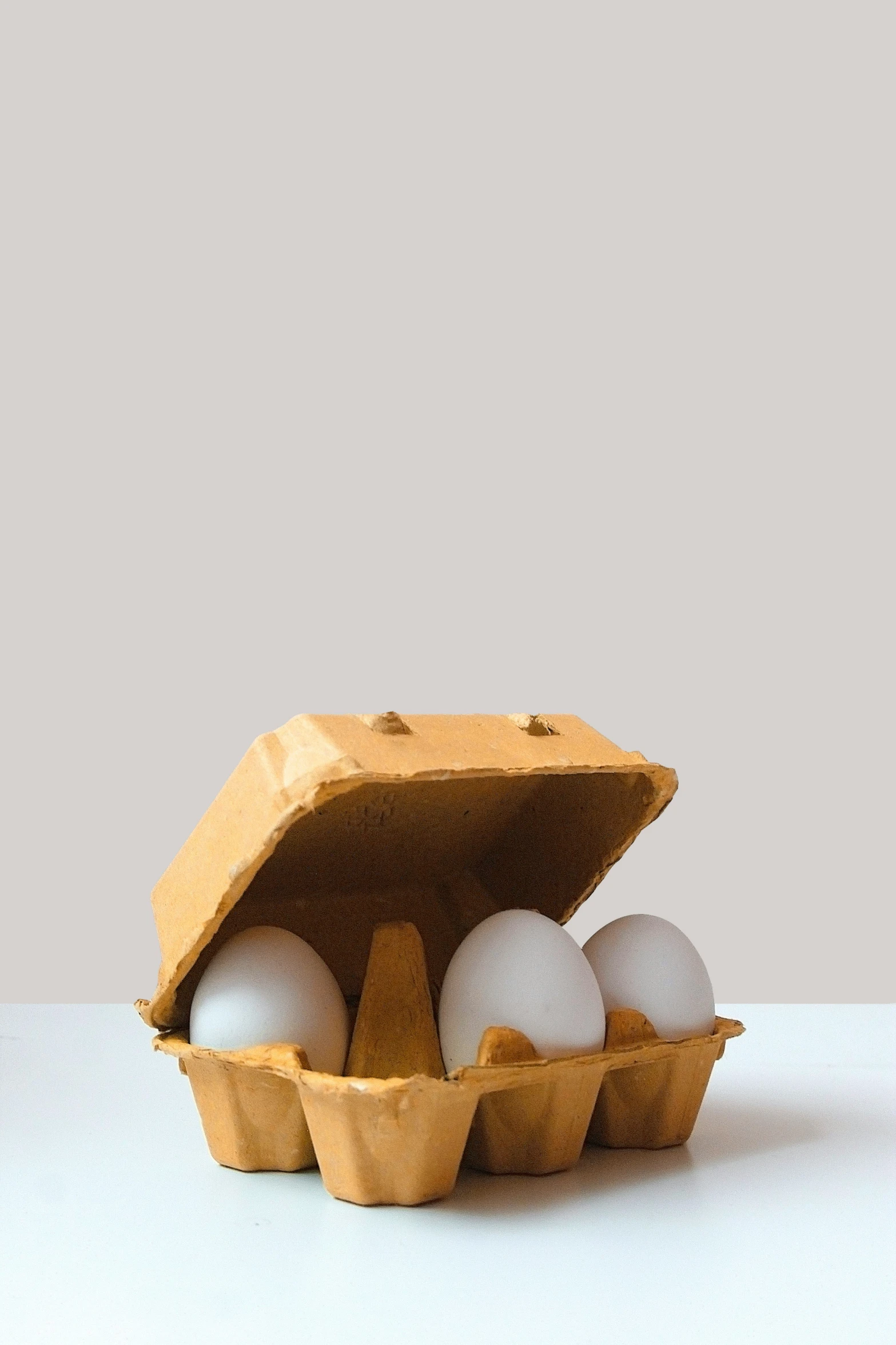 an egg box with eggs sitting in it