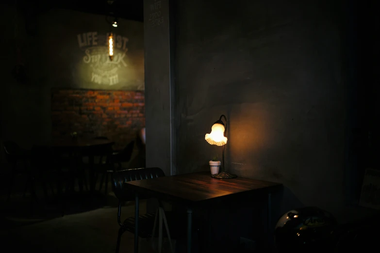 a lit desk in a dark room with a light on