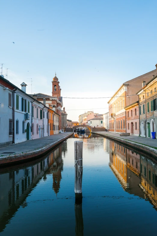 the reflection of buildings on the water's surface is seen in the foreground