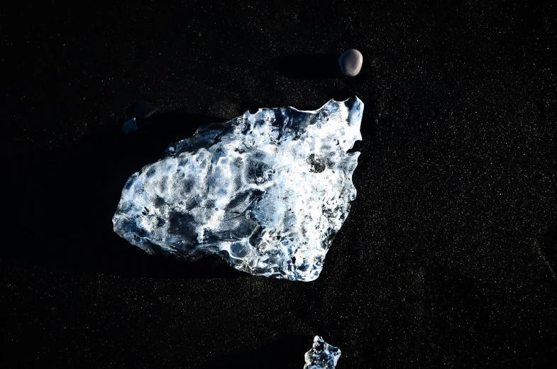 a rock that has a small white substance on top