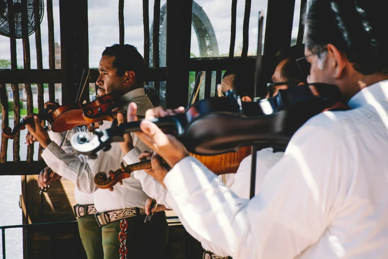 a group of people holding up a violin