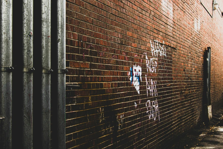 a black and white po of graffiti on a brick wall