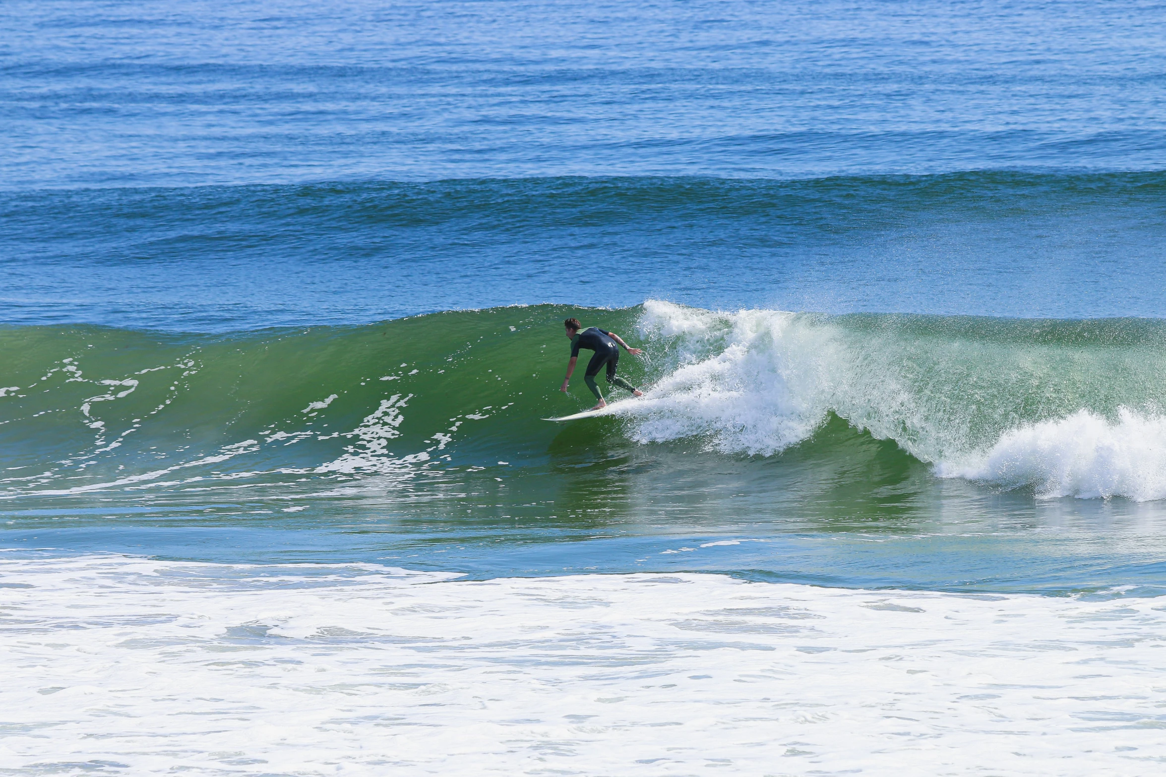 person surfing the crest of an ocean wave