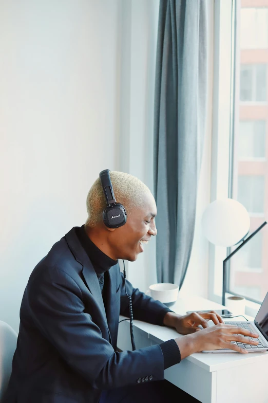 man with headphones on working on a computer