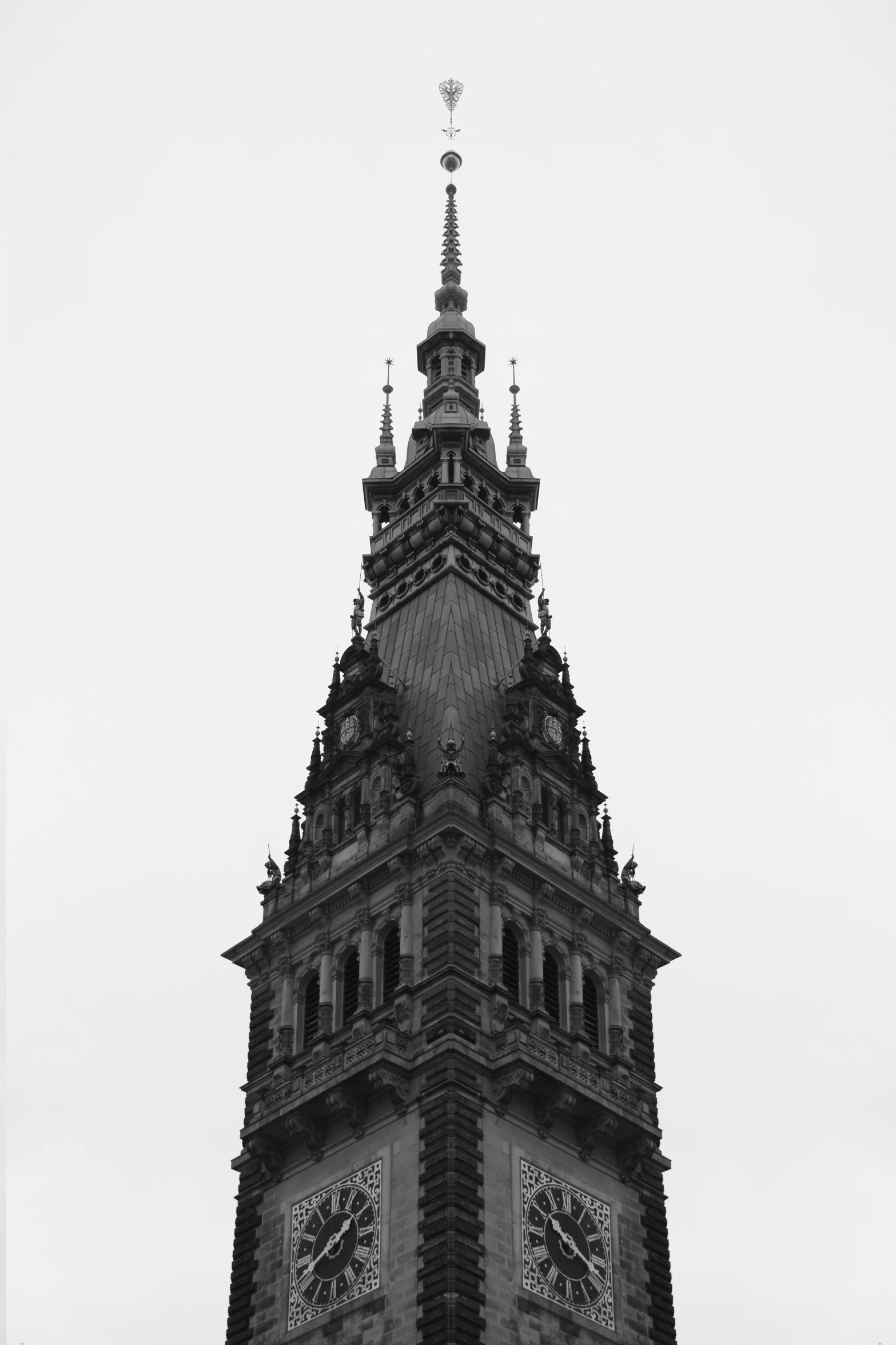 a tall clock tower with multiple clocks on each of the sides