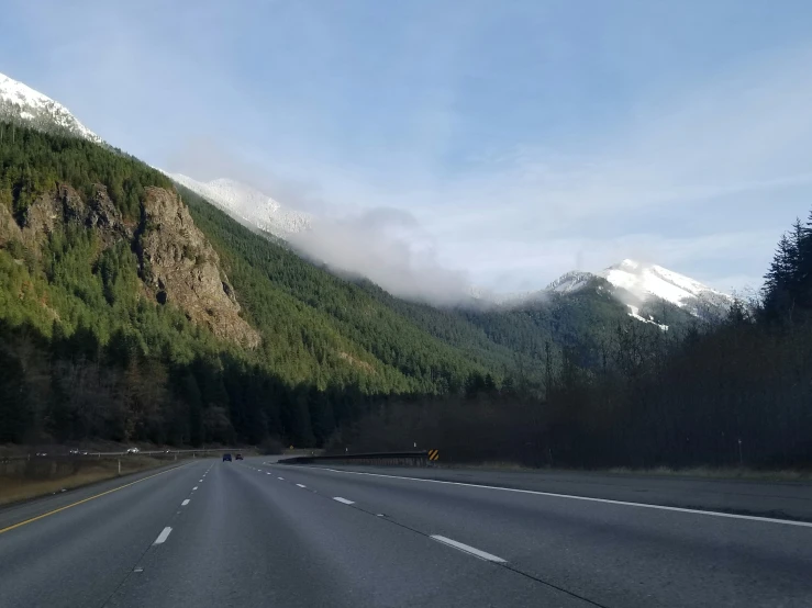 a mountain road passing by a mountain side