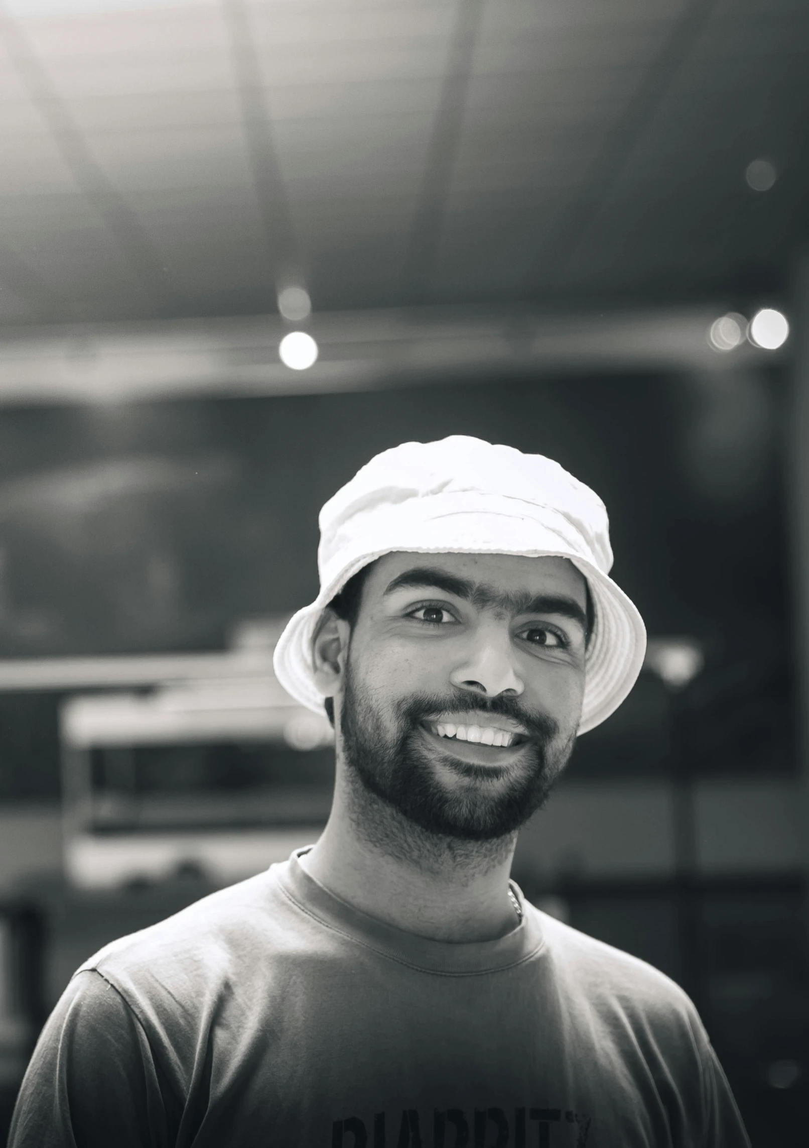 a man in a hat posing for a pograph