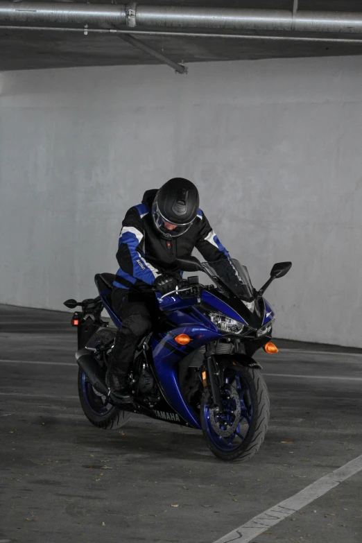 person riding on the back of a motorcycle in an parking lot