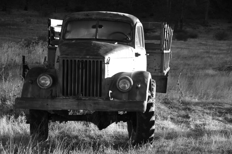 a black and white po of an old vehicle in a field