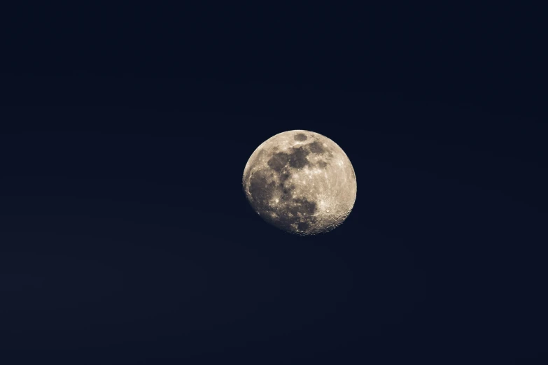 a big moon is shown against the dark sky