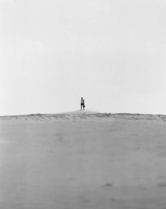 two people walk in the distance across a large open expanse