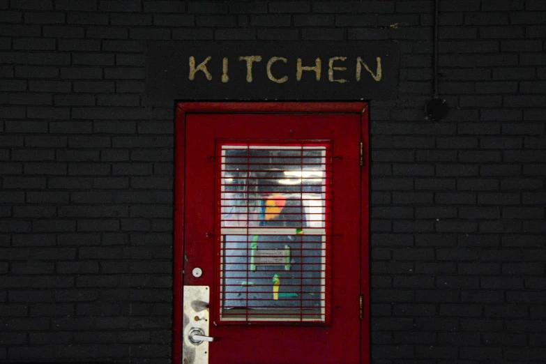 the red door has an open window with bars in it