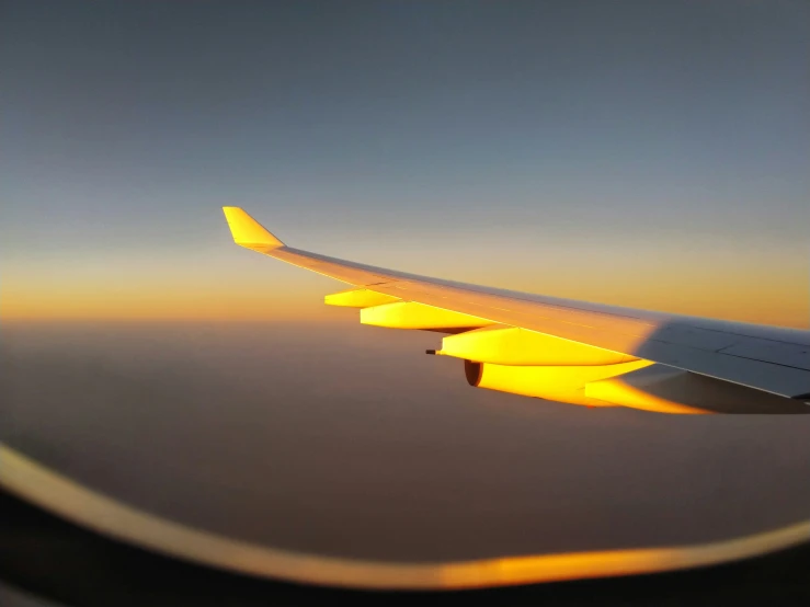the view of an airplane wing from inside the plane