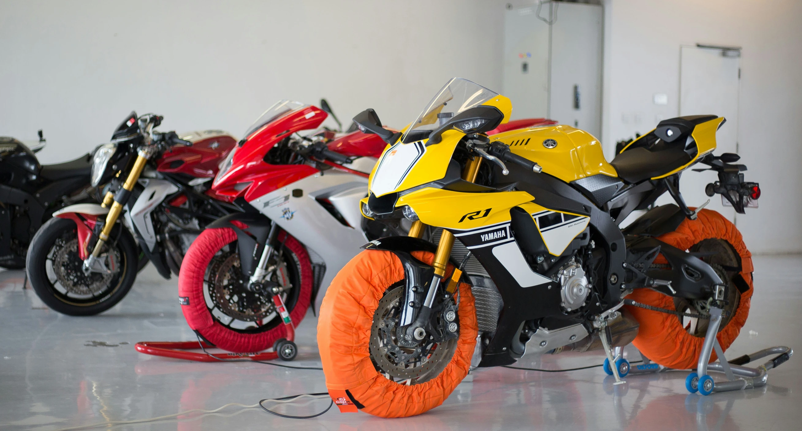 a row of motorcycles parked inside of a building