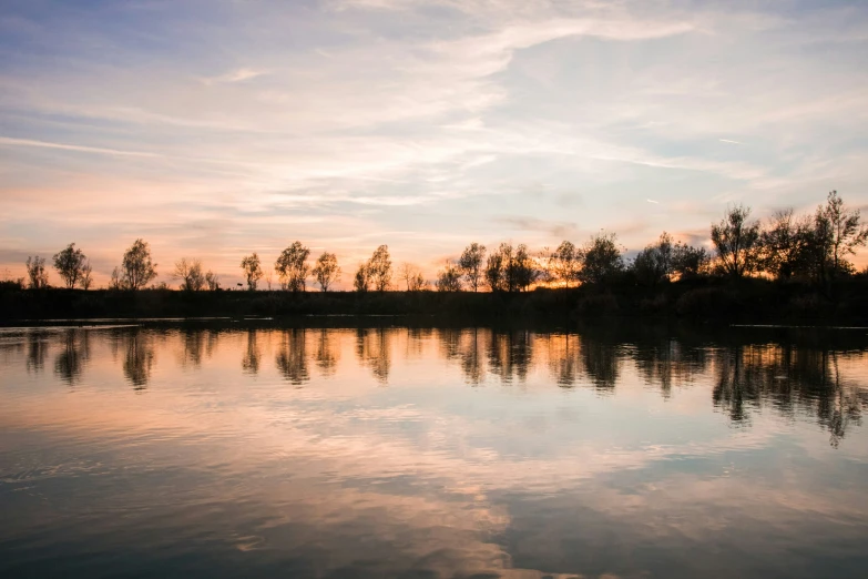 a body of water under a cloudy sky