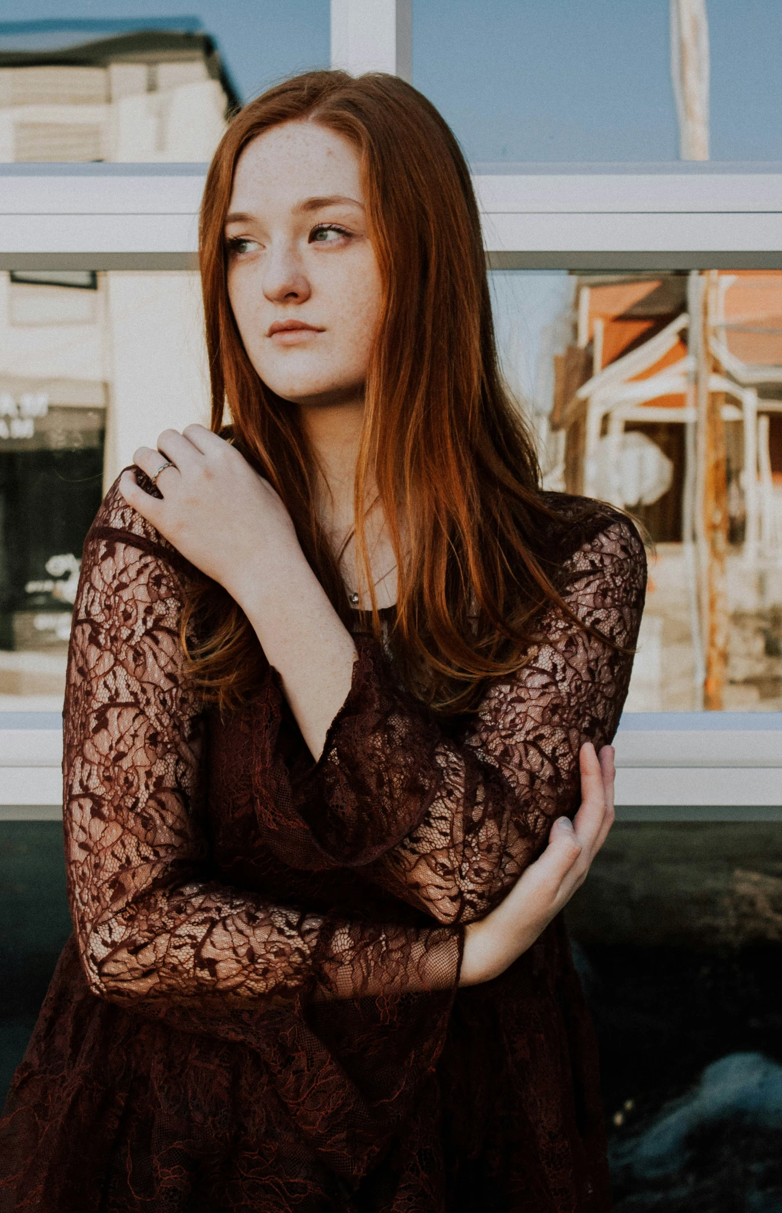 young woman in dark dress posing outside for picture