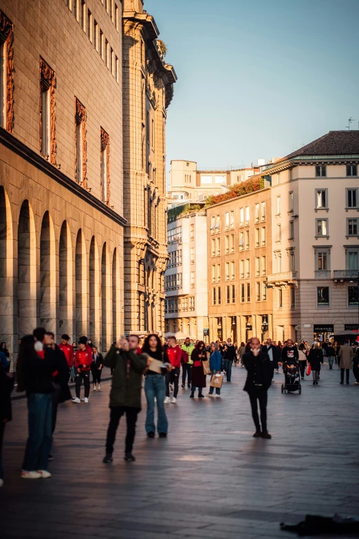 a crowd of people standing around an old building