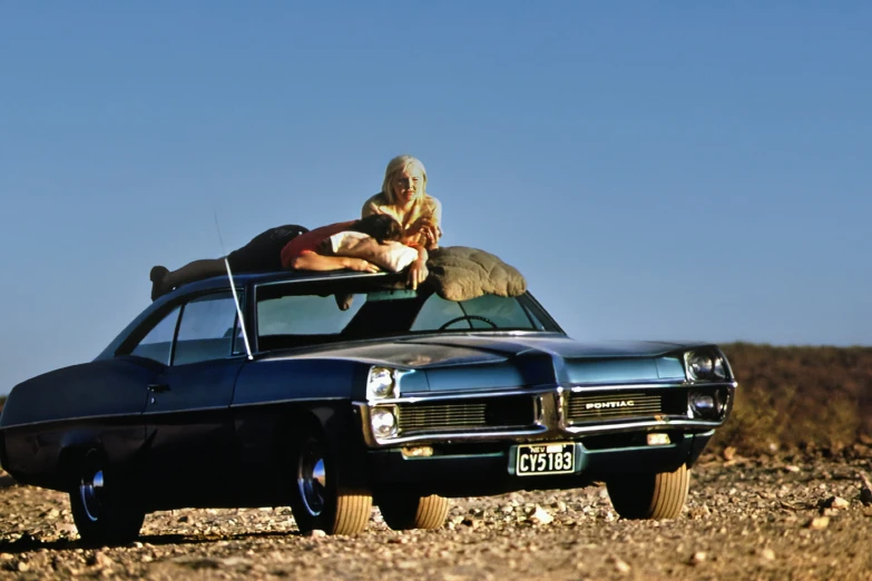 a man in the back of a truck pulling a man on