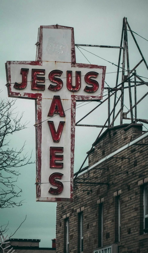 a sign for a store called jesus saves on a building