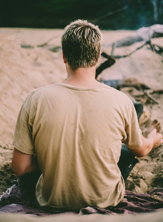 a man sitting alone on the beach