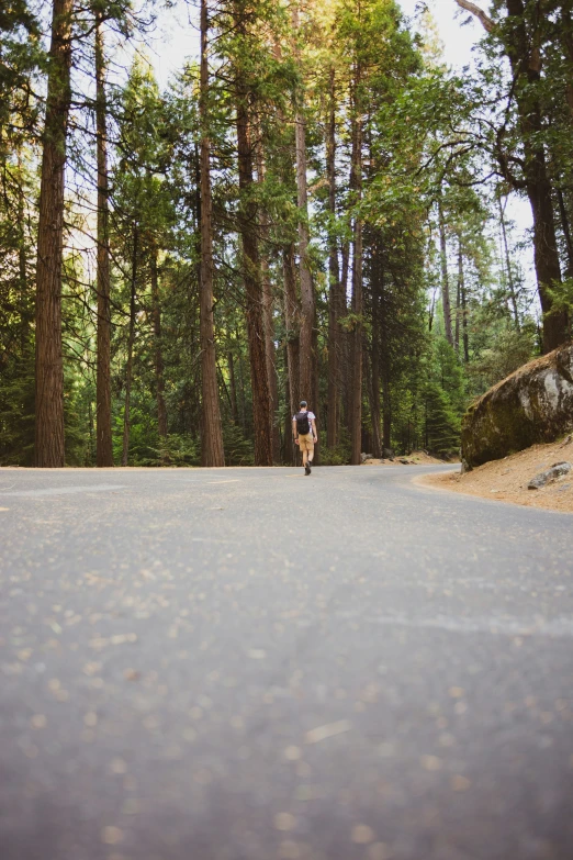 a person that is riding a skateboard in the road