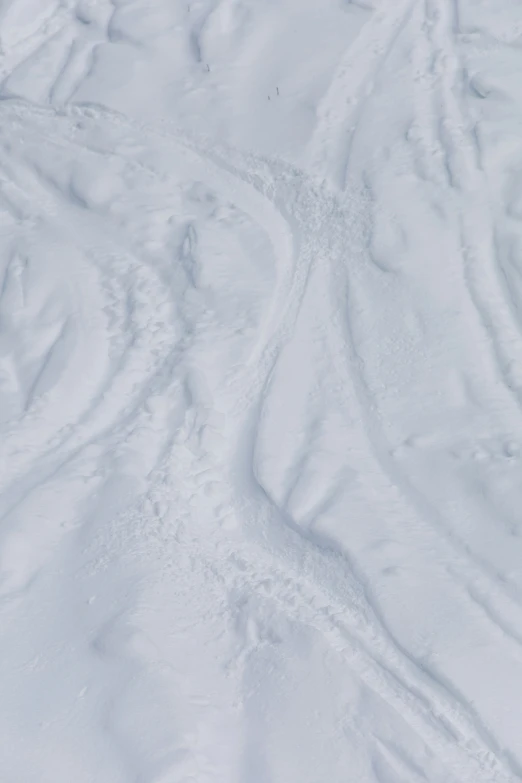 a skier in yellow jacket going down a snowy hill