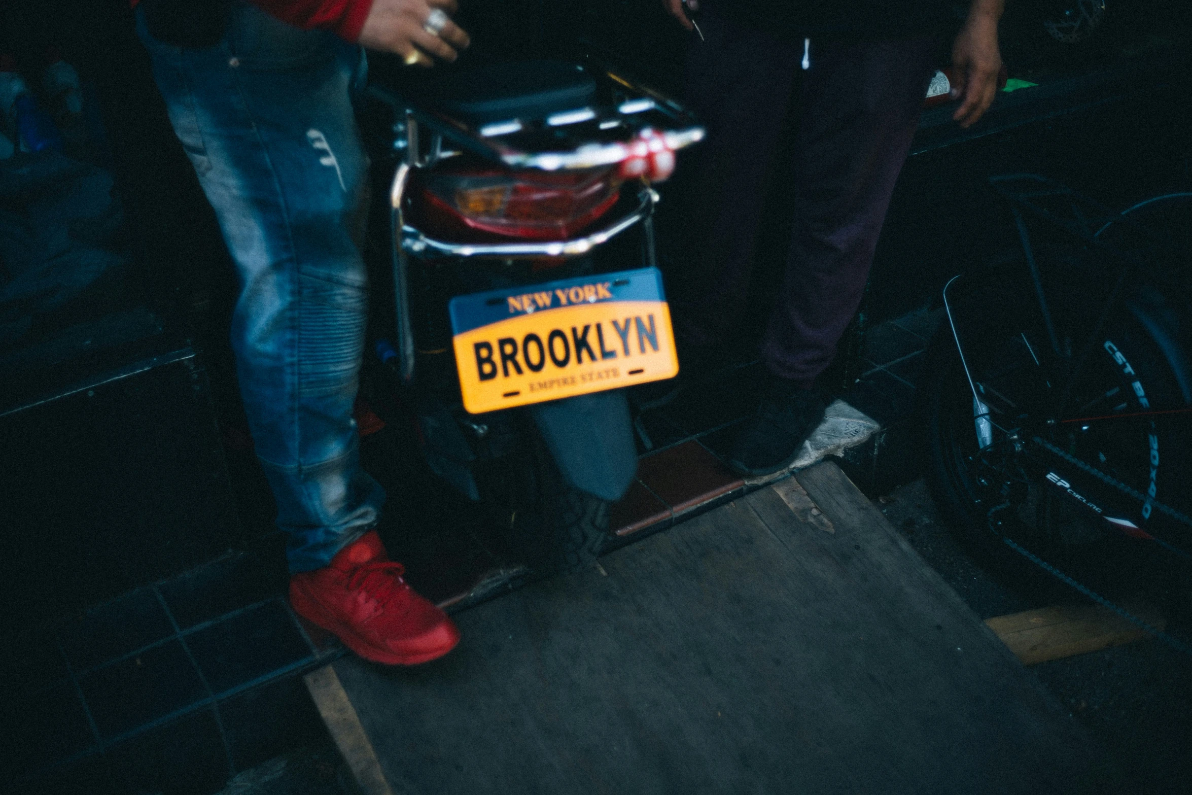 a bike with a sign attached to it next to some people