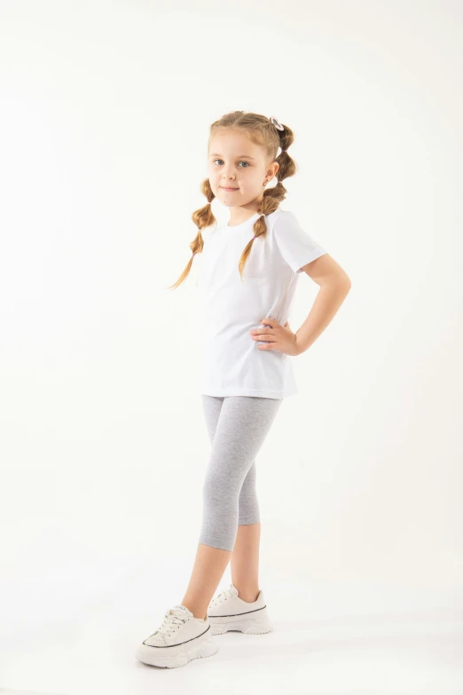 a  posing for the camera while wearing grey and white tights