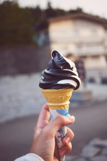 a woman holding a chocolate gelato ice cream cone