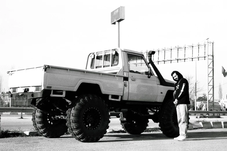 a couple of people are posing next to a truck