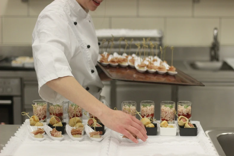 a chef preparing food on a long table