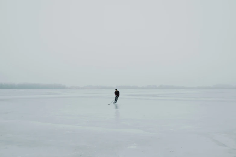 a person standing in the middle of a large expanse