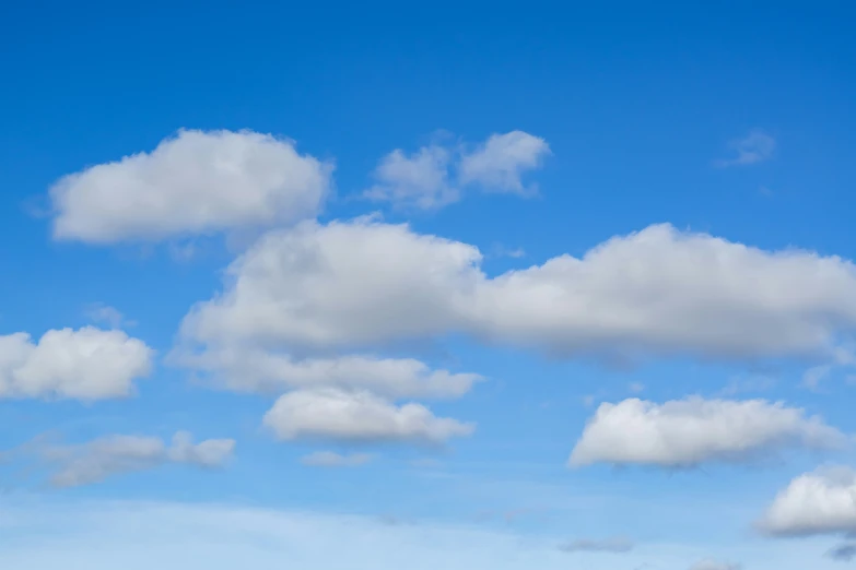 an airplane flying in the air near some clouds