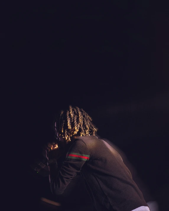 an african american male on stage performing a musical performance