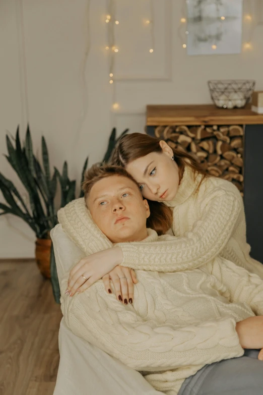 a couple is lying down on the couch with their arms around each other