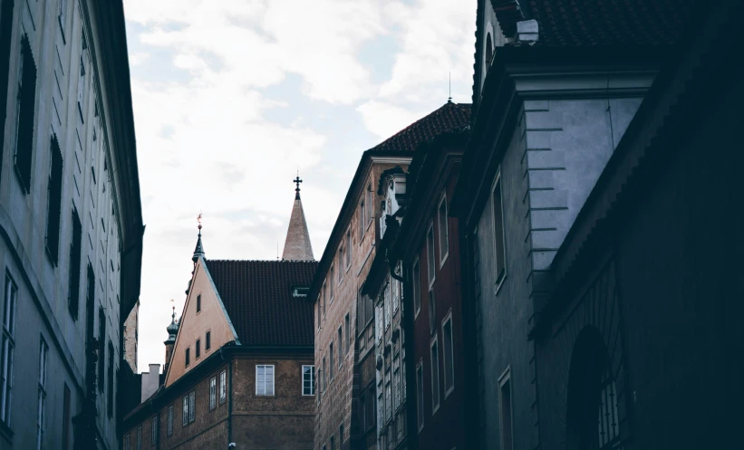 a narrow street with tall buildings between two rows