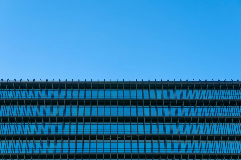 a plane is flying over the windows of a building