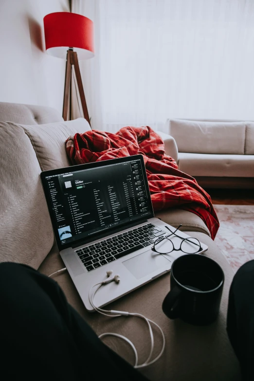 a laptop computer is sitting on top of the coffee table