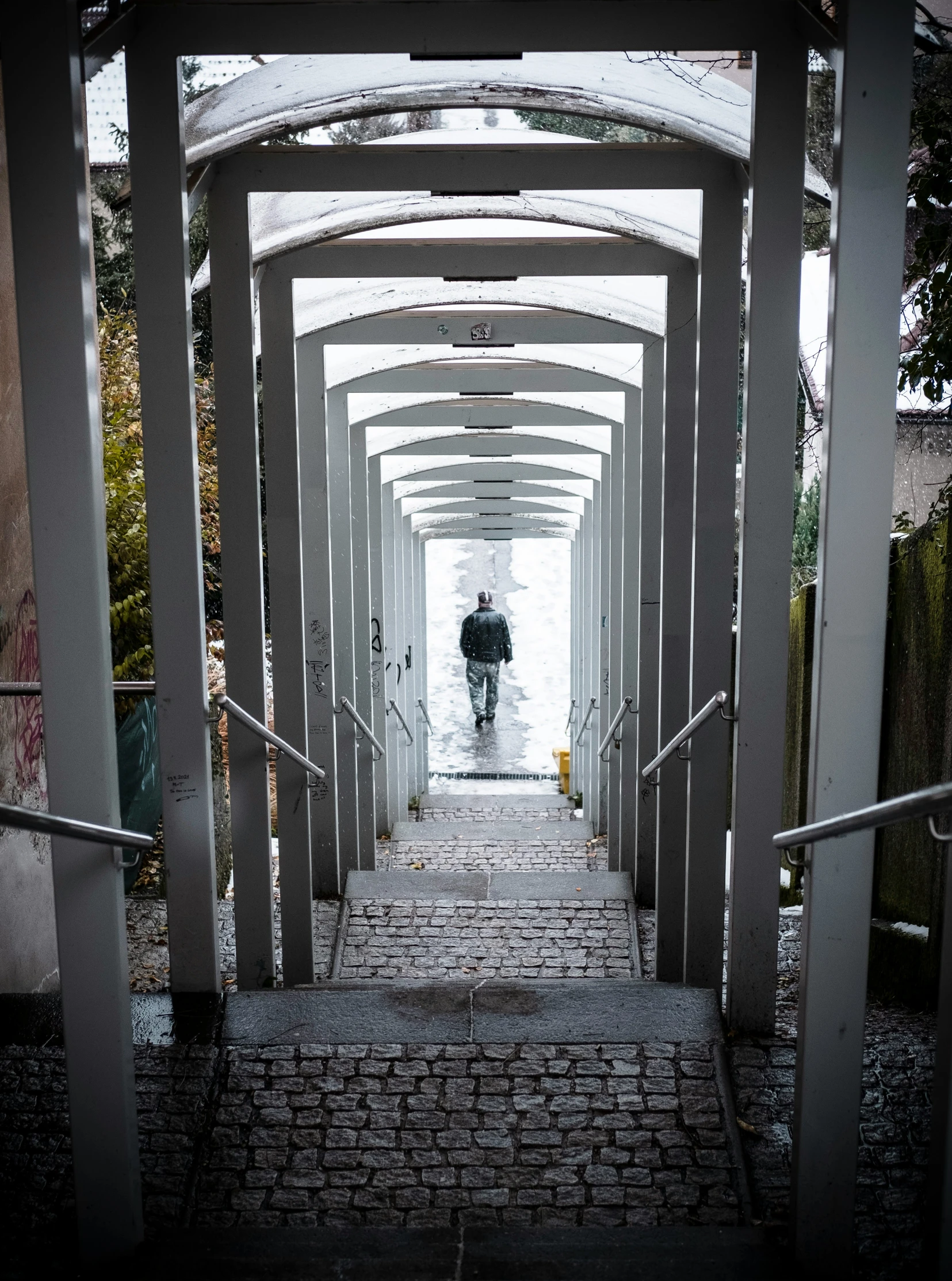 a person carrying an umbrella going up a path