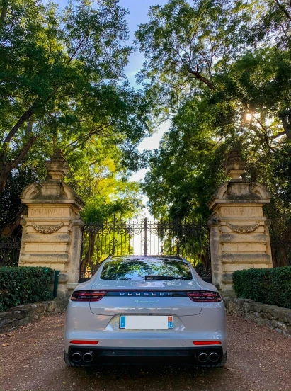 a car parked near an open gate and a building