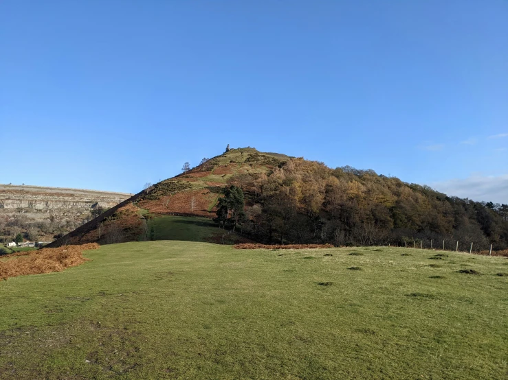 there is a large hill with a hill in the distance