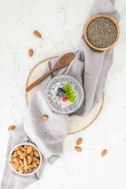 almonds and other nuts on the table next to a bowl