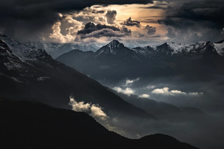 dark mountains and sky with clouds above them